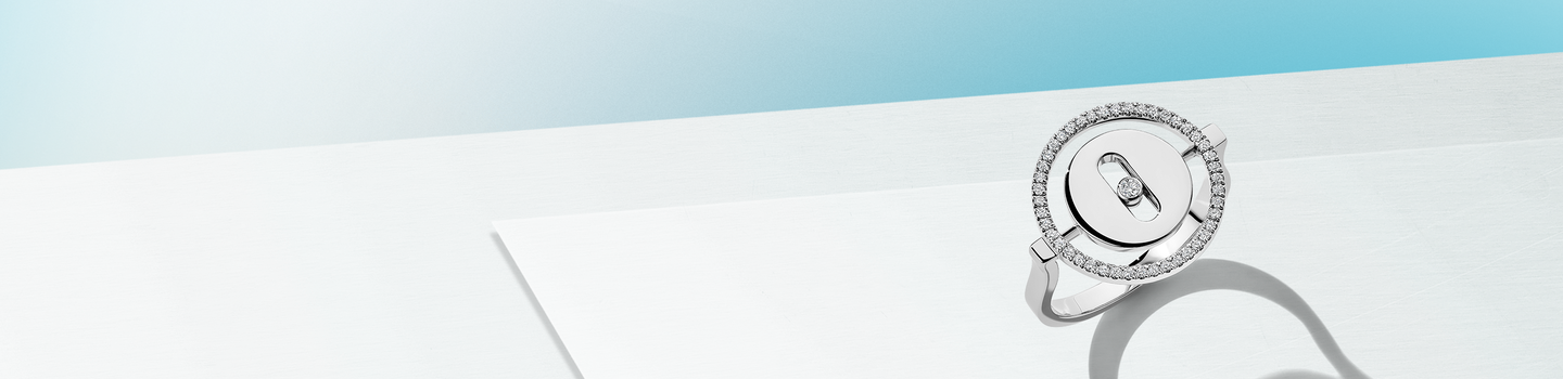 Messika round diamond ring on a baby blue and light blue background